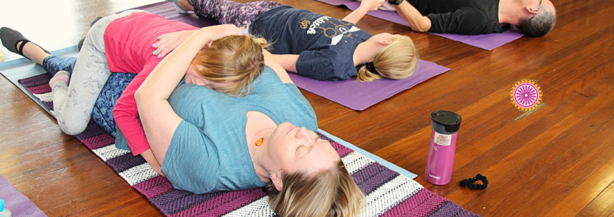A family relaxes at Shine Oms free community to celebrate ACT Chidlrens week in Canberra.