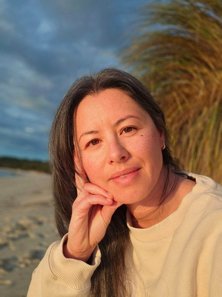 We chat with Natalie Olson on Authentic Motherhood, Nervous System care and Repair and Rupture on The Breathe, Laugh, Parent - The Shine Om Podcast. Visit www.shineom.com.au/podcast to learn more.

This is image is of Coach Natalie Olson smiling in soft natural light—authentic motherhood and nervous system care