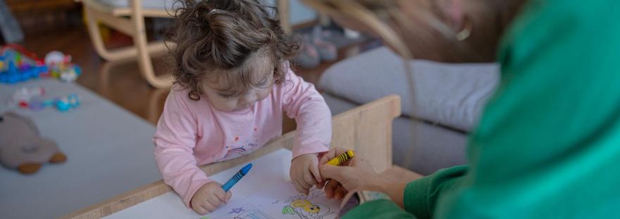 Mother and toddler colouring together at table for calming ritual to build calm into your family’s day. Visit https://shineom.com.au/mindfulcolouringbookforkids to learn more.